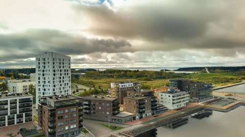 Riverfront city with bridges and autumn trees — Stillmotion