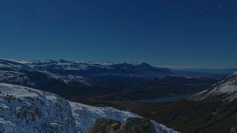 Snowy mountain lake at night — Stillmotion