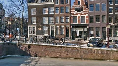 Frozen canal cityscape with bridge — Stillmotion