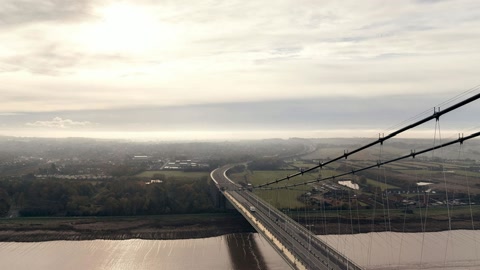 Suspension bridge over wide river — Stillmotion