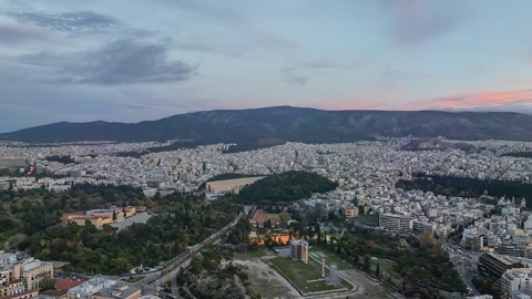 Dense city under cloudy skies — Stillmotion